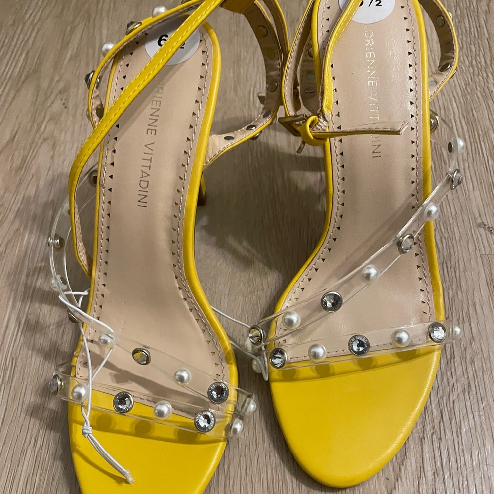 Yellow, pearl heels/sandals with clear strap.
